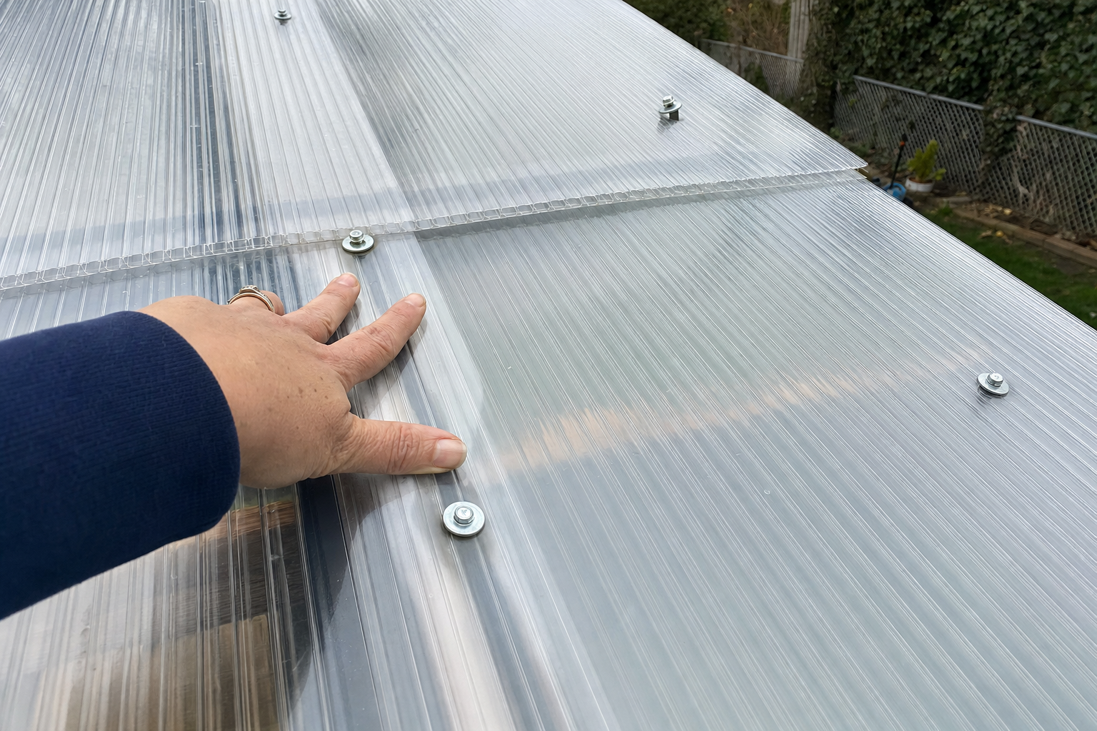 Polycarbonate roofing panels installed on a pergola structure in a Long Island backyard